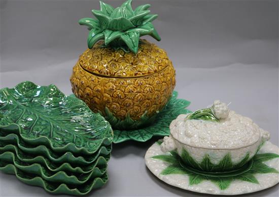 A Majolica cauliflower tureen, green leaf plates and pineapple bowl and cover